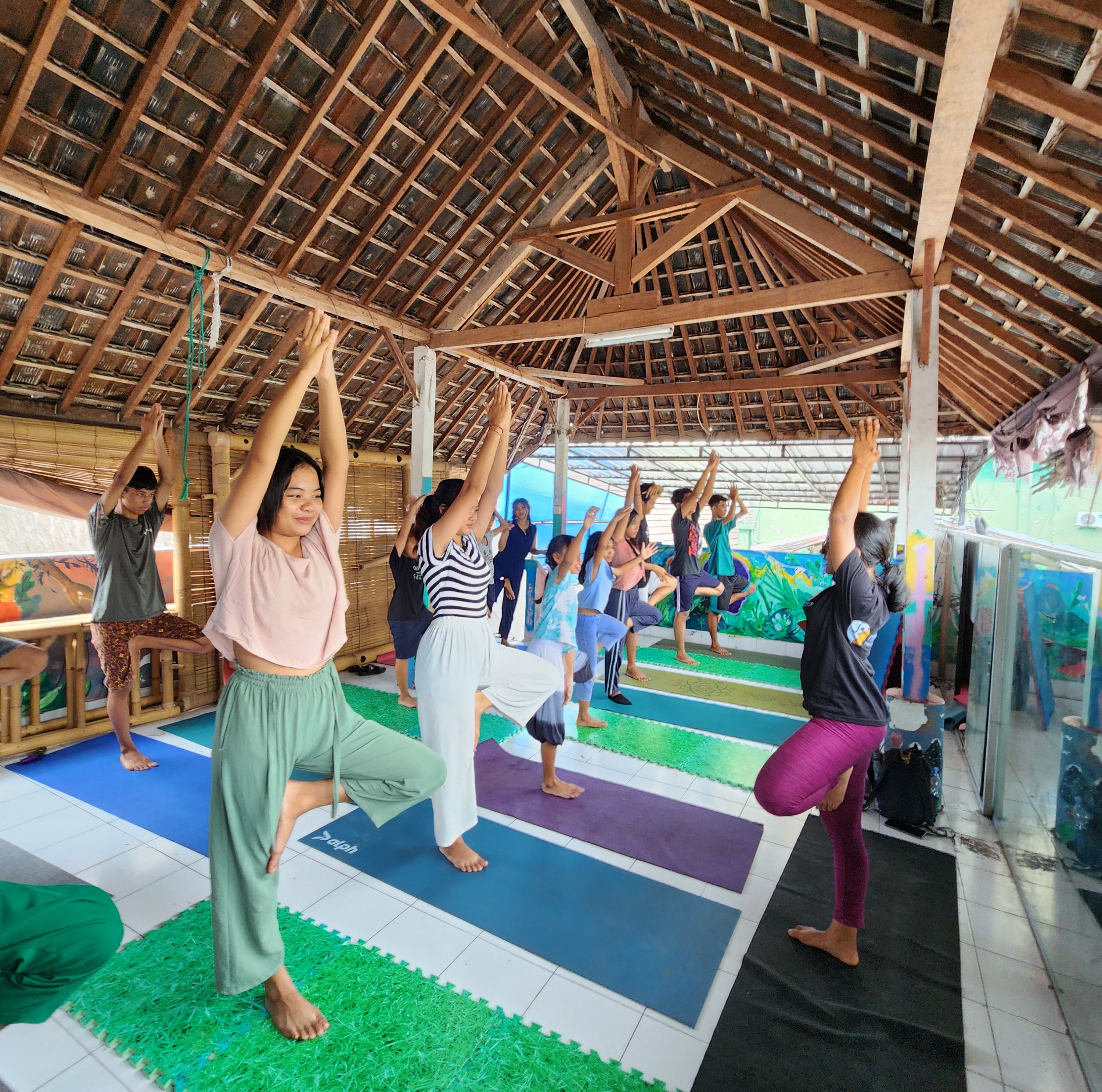 people meditating on their yoga mats in a open place